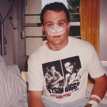 The author during his boxing career, sitting on hospital bed, with broken nose bandaged up.
