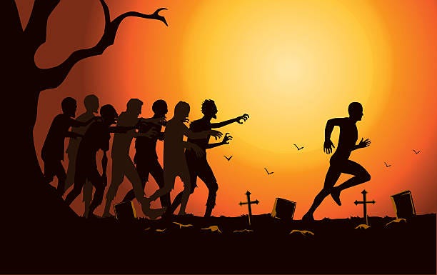 Zombies chasing a man in cemetery