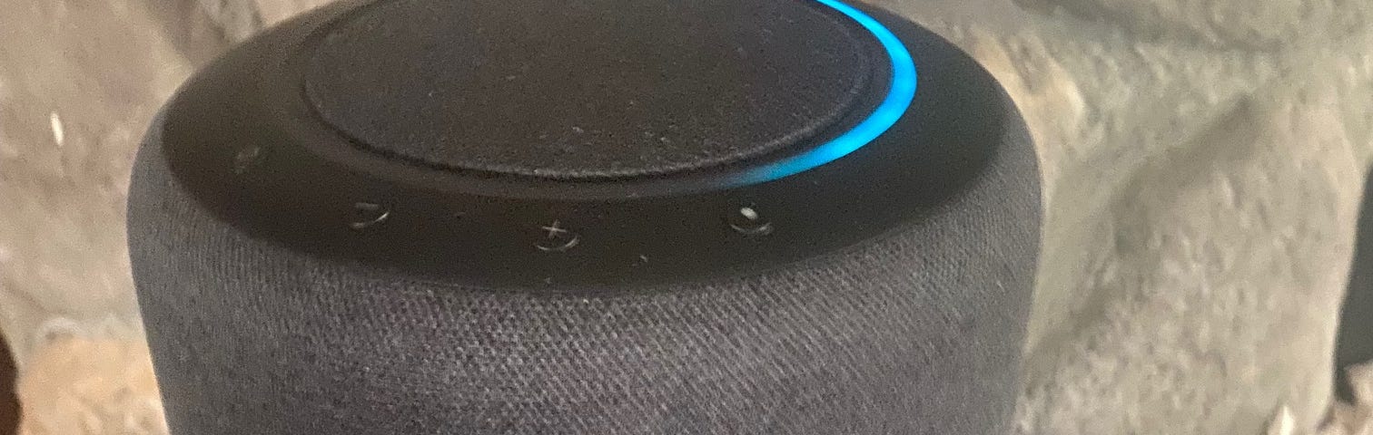 Alexa unit with blue lights flashing as she is talking.