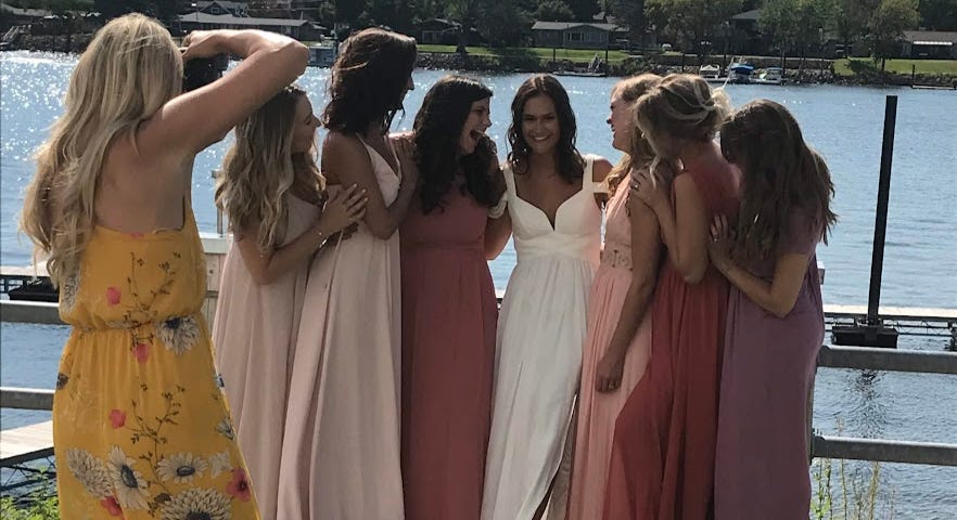 Friends posing for a wedding party photo