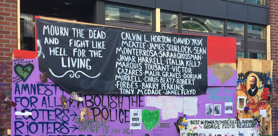 An image of multiple murals, signs and graffiti from Seattle’s CHAZ/CHOP protest zone in 2020. Signs say things like “Amnesty for all looters, rioters and protesters” and “Abolish the police” as well as memorials for Black people like George Floyd who had been killed by the police leading up to the protests.