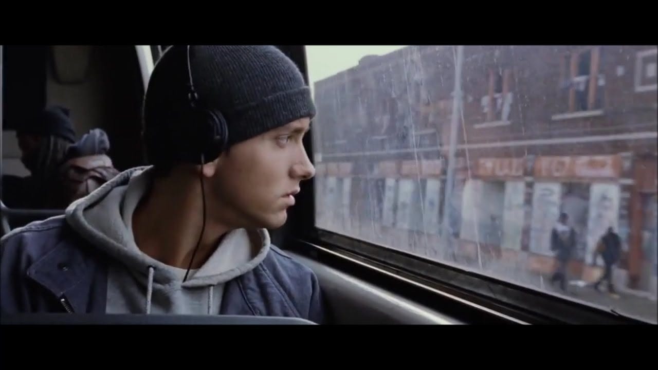 eminem from 8 mile staring out the window on a train.