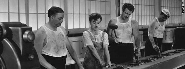 Still from the motion picture ‘Modern Times’ from Charles Chaplin showing a worker on a manufacture line.