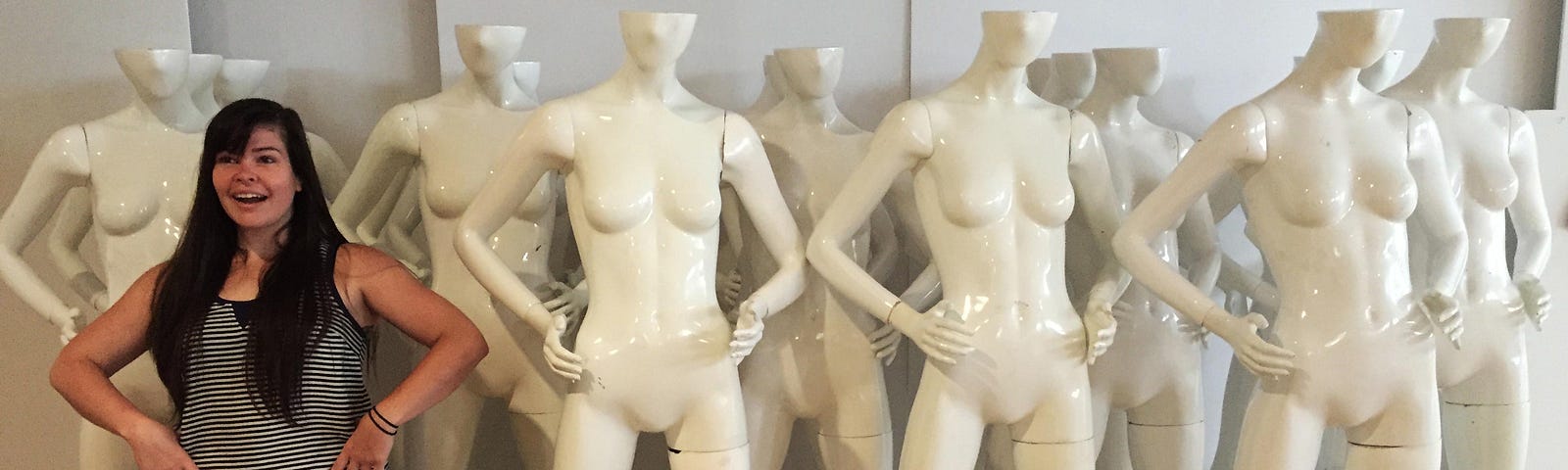Kate Murphy standing with multiple store mannequins
