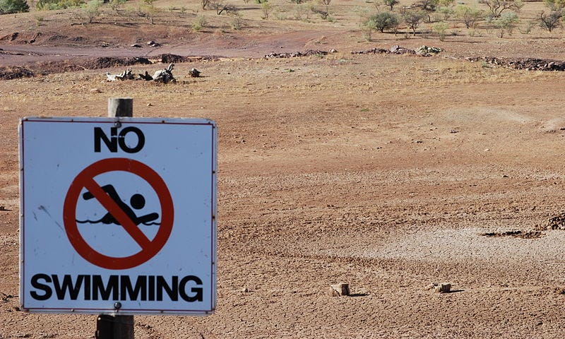 To accompany the article World Water Day. A dry swimming hole with the sign NO SWIMMING.