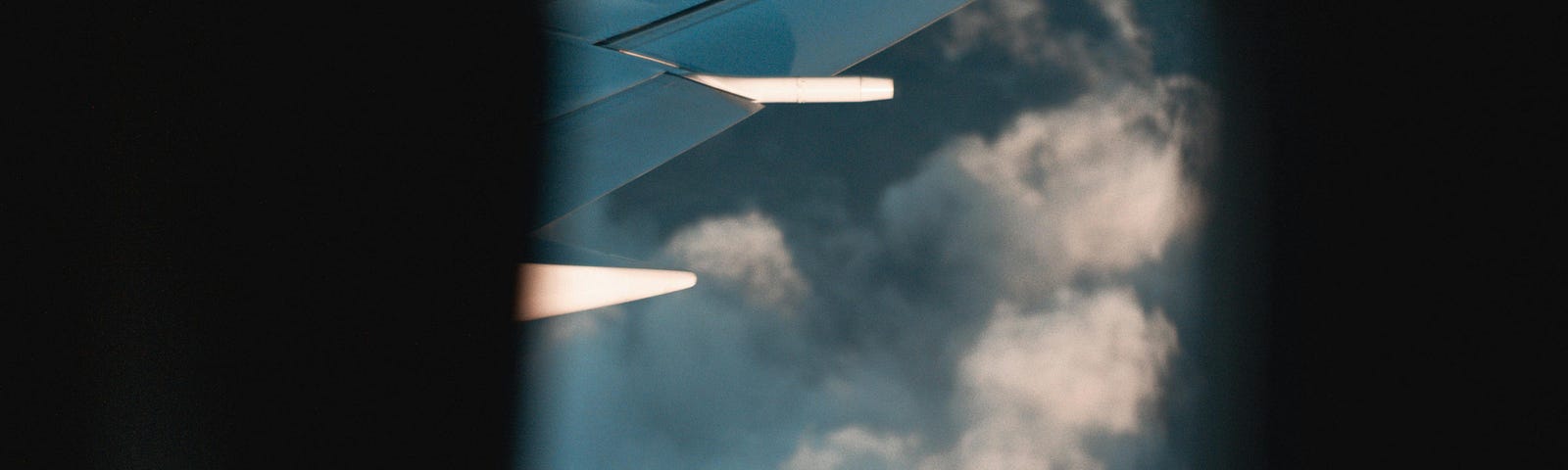 Abstract view of plane wing in clouds