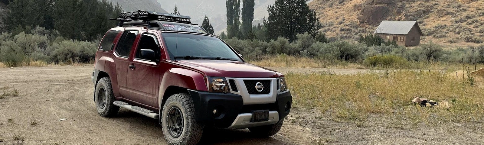 The author’s red 2010 Nissan Xterra S., nicknamed “Big Red” parked on a dirt road.