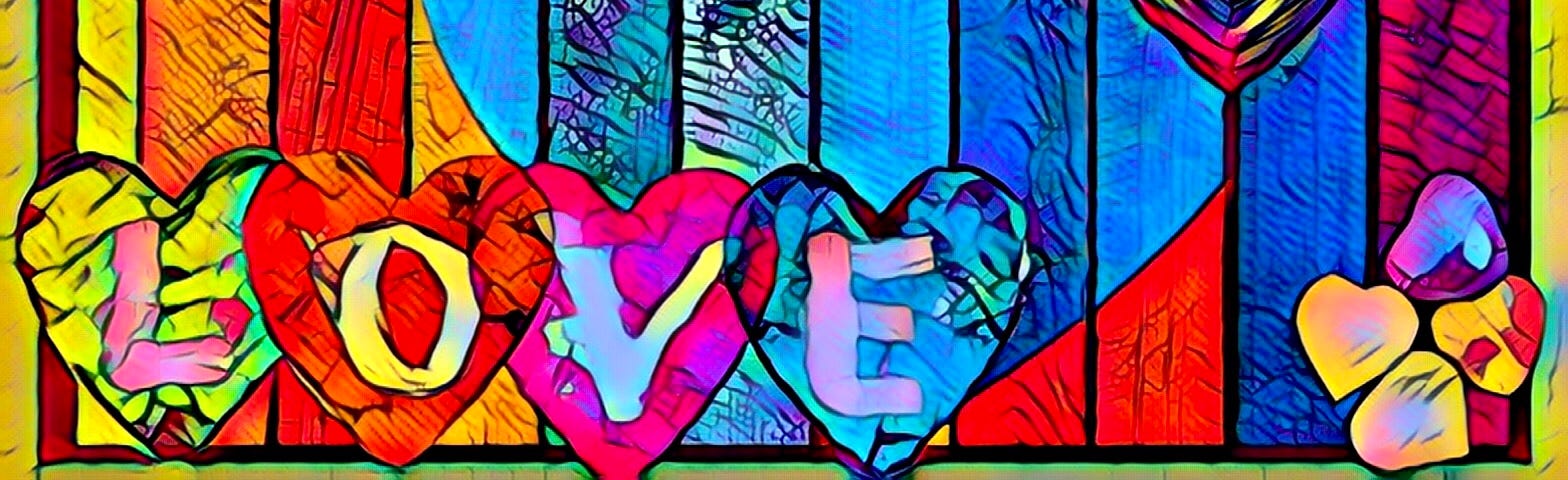 The word LOVE in colored hearts in front of a colored paneled fence