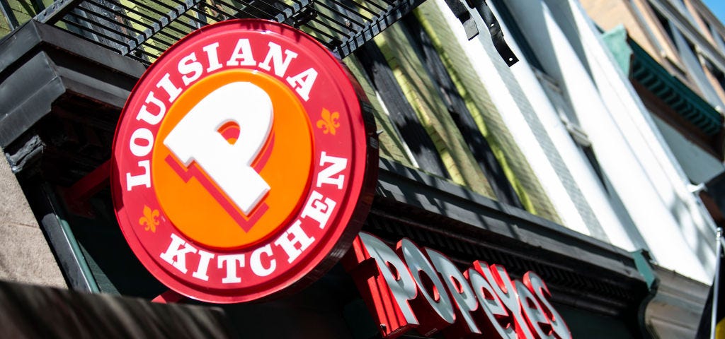 A photo of a Popeyes store front and logo.