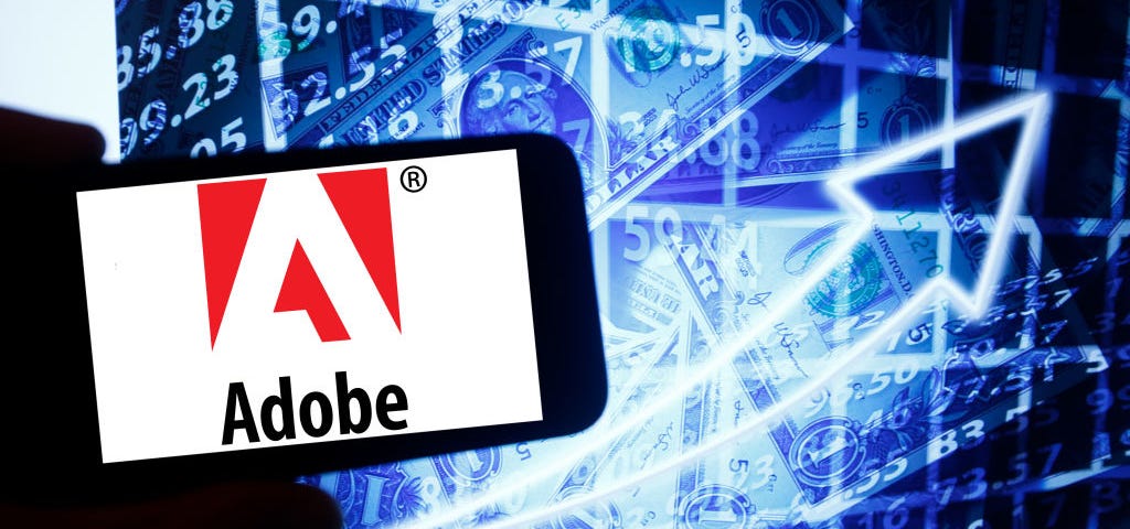 A photo of Adobe’s logo on a smartphone.