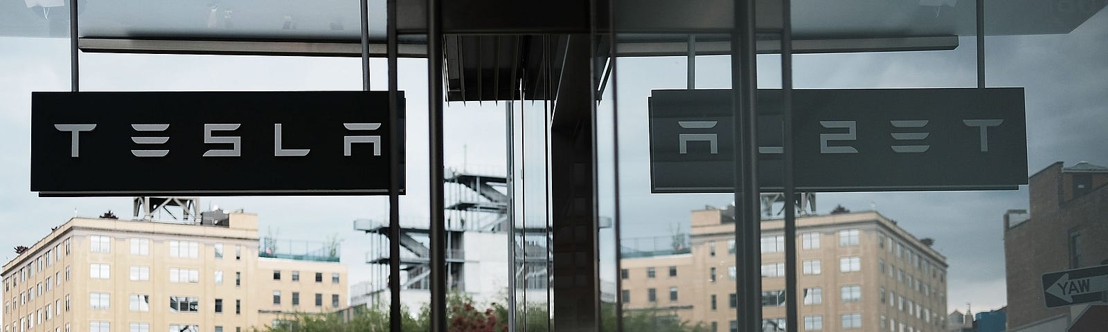 People walk by a Tesla showroom in the Meatpacking district in Manhattan