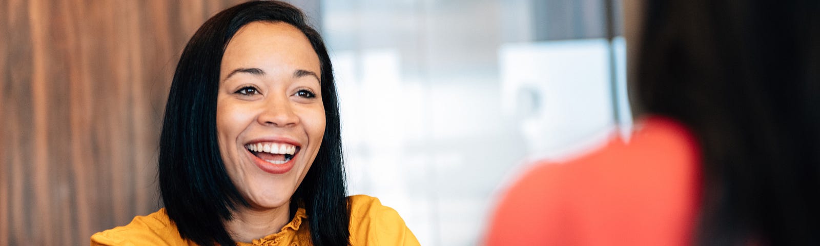 A photo of a woman talking during a job interview.