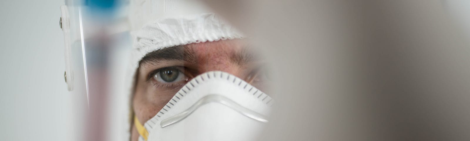 In a chemistry lab, a male researcher holds a tube with the coronavirus virus.