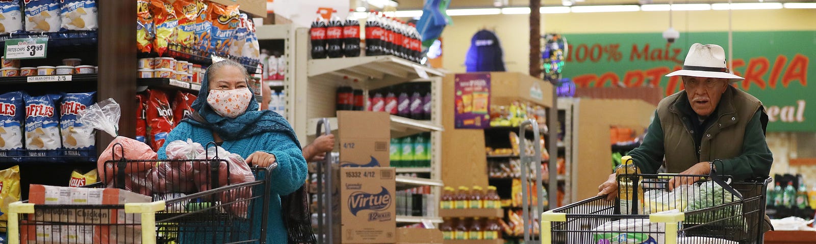 Seniors shop for groceries at Northgate Gonzalez Market in Los Angeles during special hours open to seniors and the disabled.