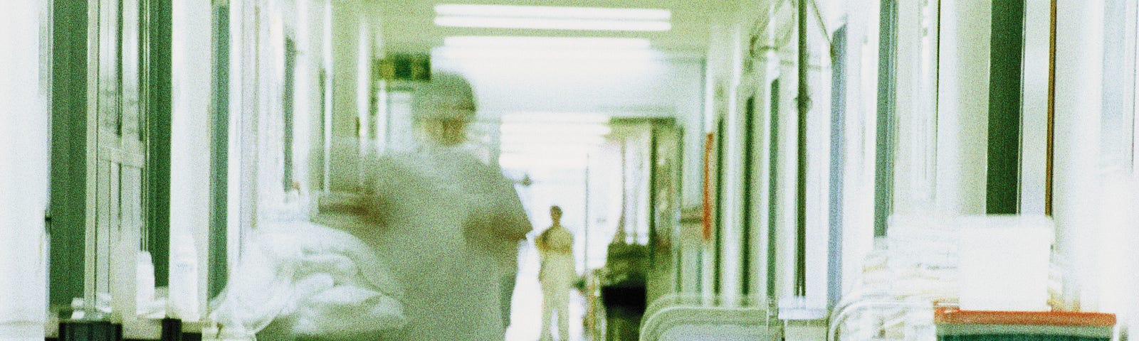 A blurry image of a hospital hallway.