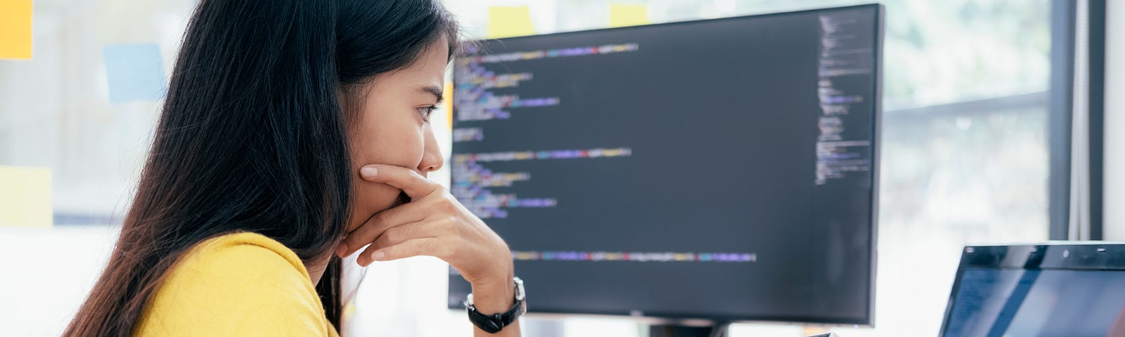 A woman looks at her laptop deep in thought, looking at the results of a business experiment.