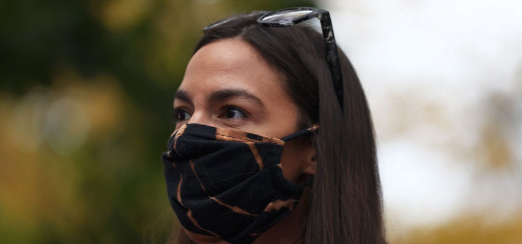 Alexandria Ocasio-Cortez wearing a face mask.