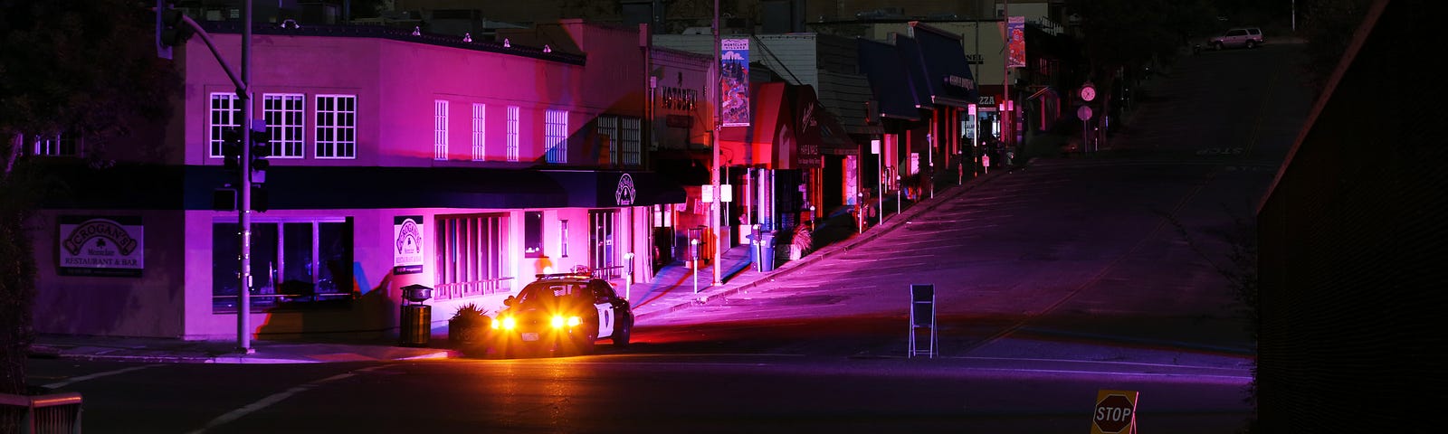 An Oakland police cruiser has its lights on in the Montclair shopping district during the PG&E California power outage.