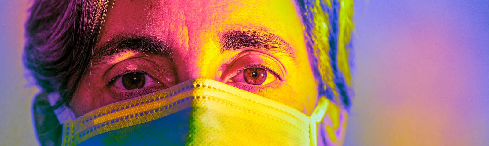 A multicolored closeup photo of a woman wearing a face mask.