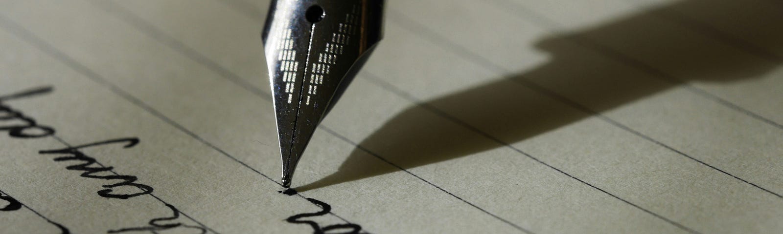 A close up of a fountain pen writing on paper