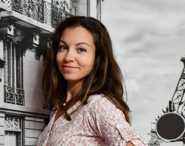 The smiling face of the author, a 33-year-old caucasian woman with blue eyes and brown hair.