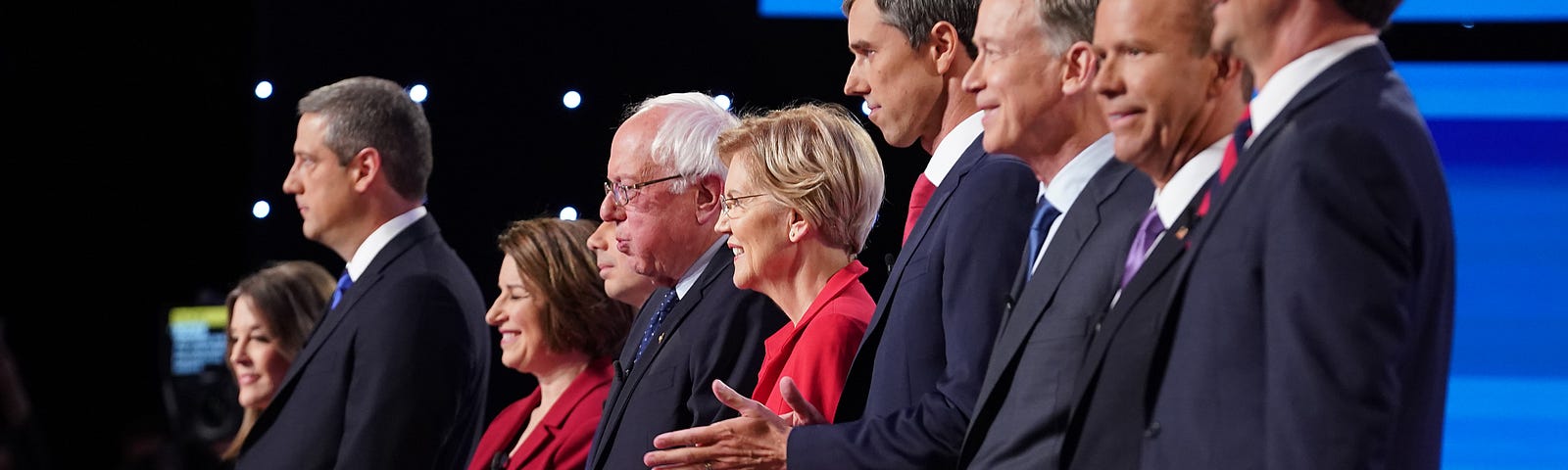 Democratic presidential candidates standing on stage at the beginning of the Democratic Presidential Debate on July 30, 2019.