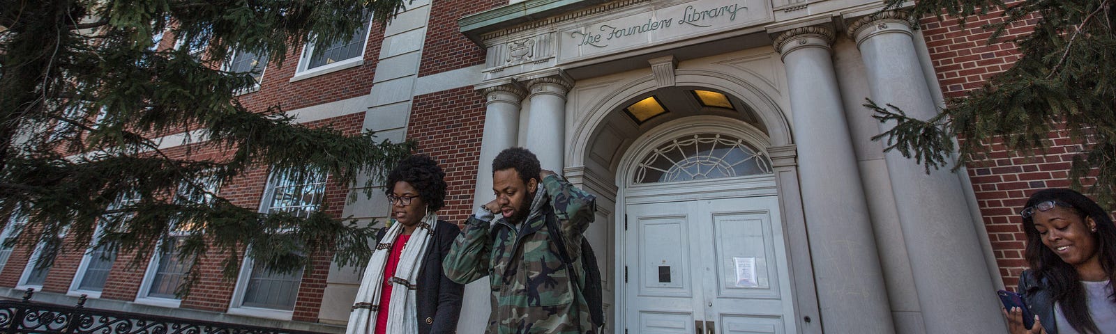 Several people outside the Founder’s Library in Howard University.