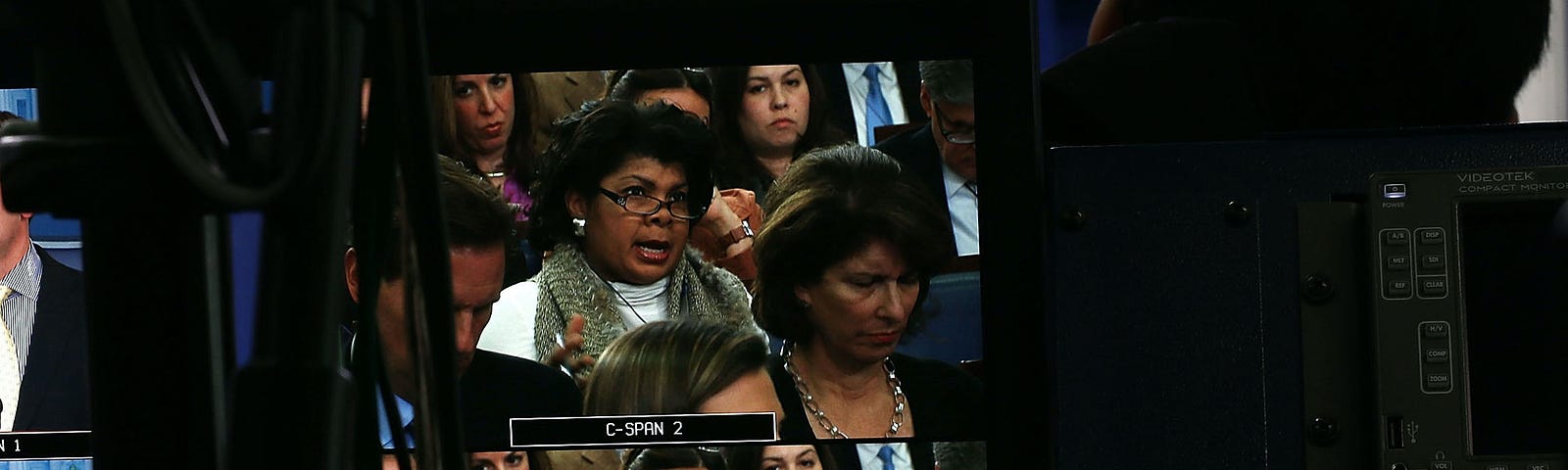 April Ryan, seen on a TV monitor, asking questions in the White House press briefing room.