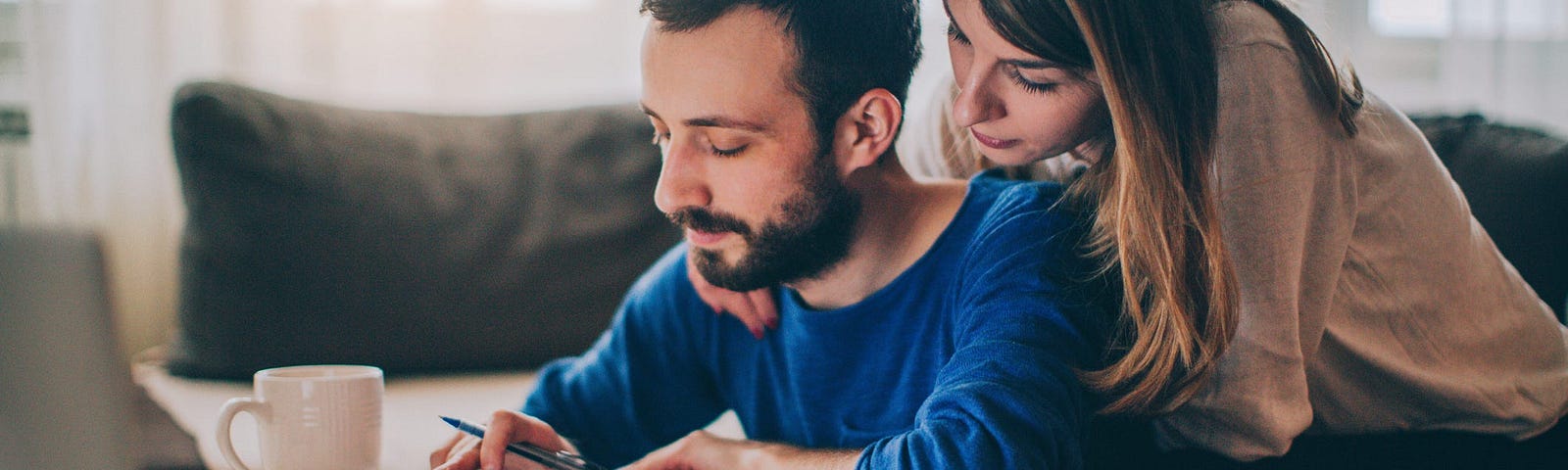 A couple looking over papers and using a calculator.