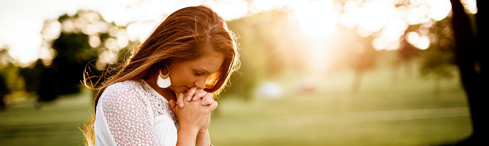 Woman Praying beside the tree