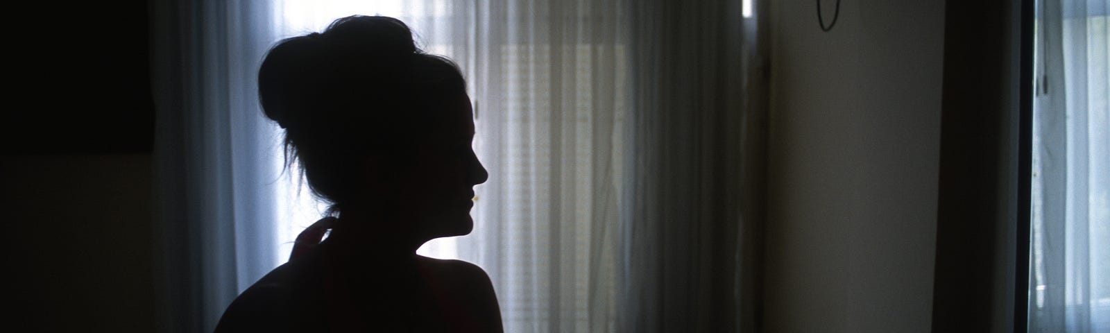 Silhouette of a woman in a room.