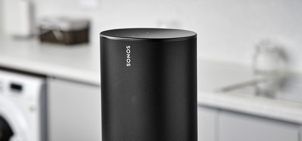 A photo of a Sonos Move on a table in a kitchen.