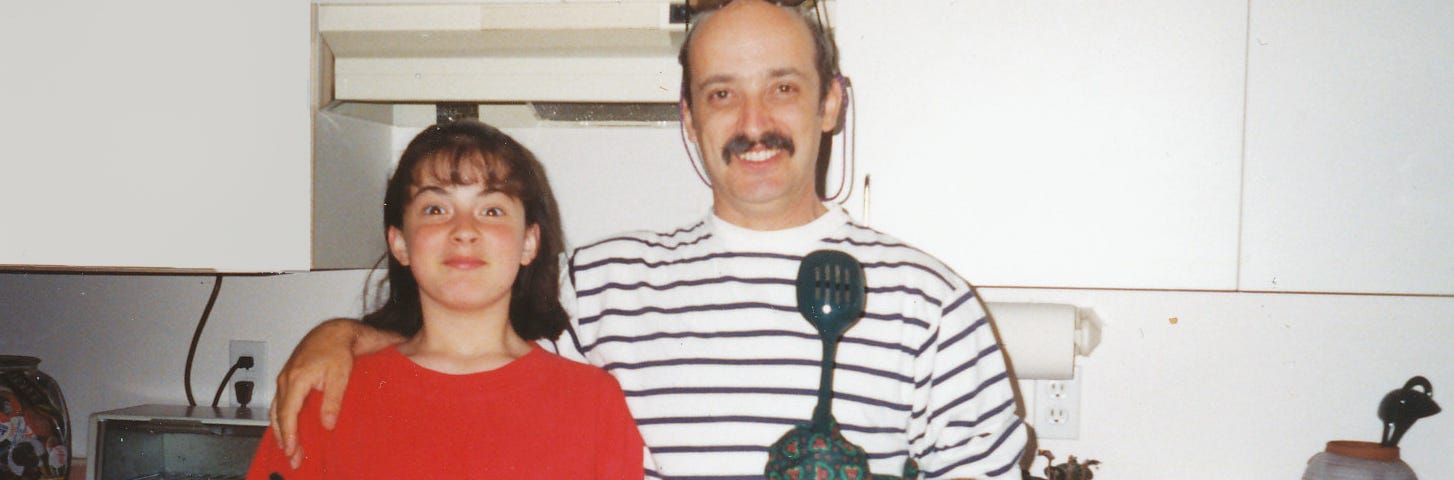 Father and daughter holding a pie