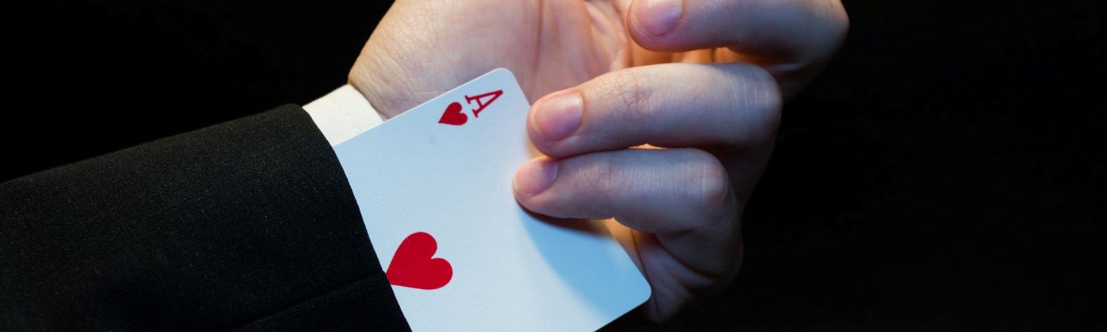 A man pulling an ace out of his sleeve.
