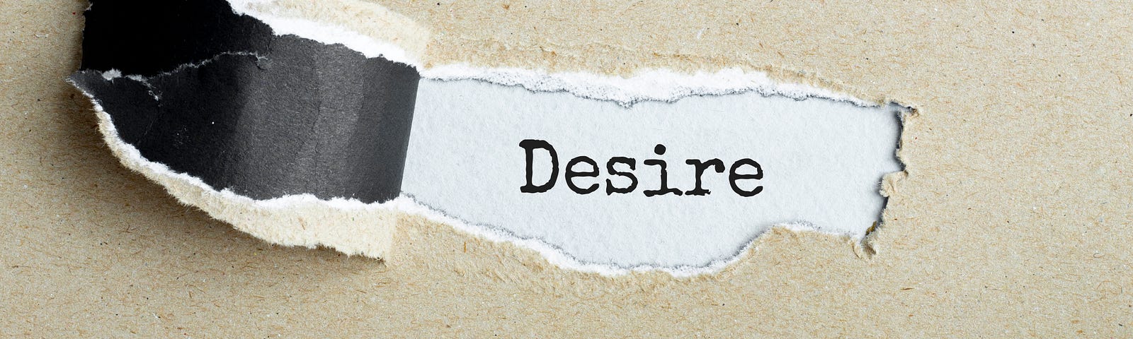 The word desire appears behind a torn piece of brown paper.