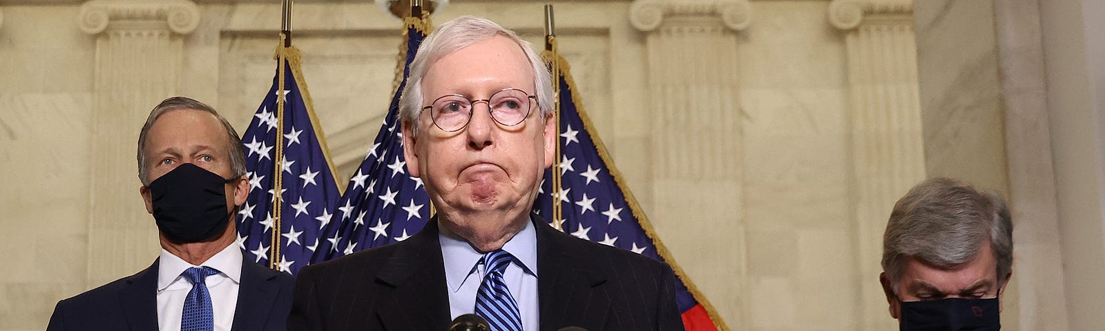 Mitch McConnell speaking into a mic.