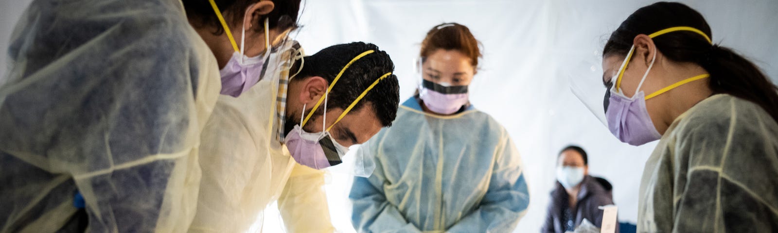 Doctors test hospital staff with flu-like symptoms for coronavirus (COVID-19) in set-up tents to triage possible COVID-19.