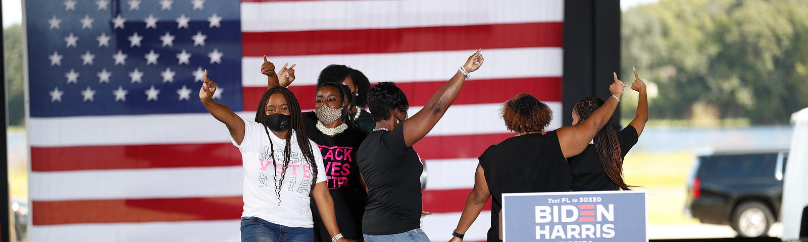 A group of AKA members dance onstage at a Biden/Harris event.