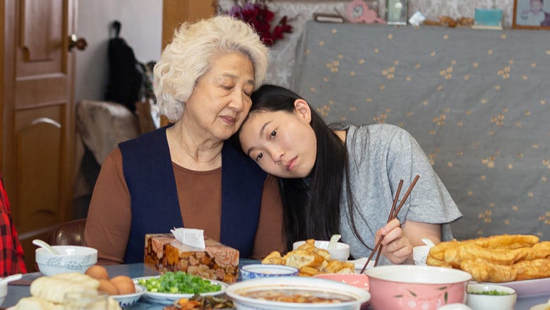 A screenshot from “The Farewell.” Awkwafina’s character leans her head on her grandmother’s shoulder.