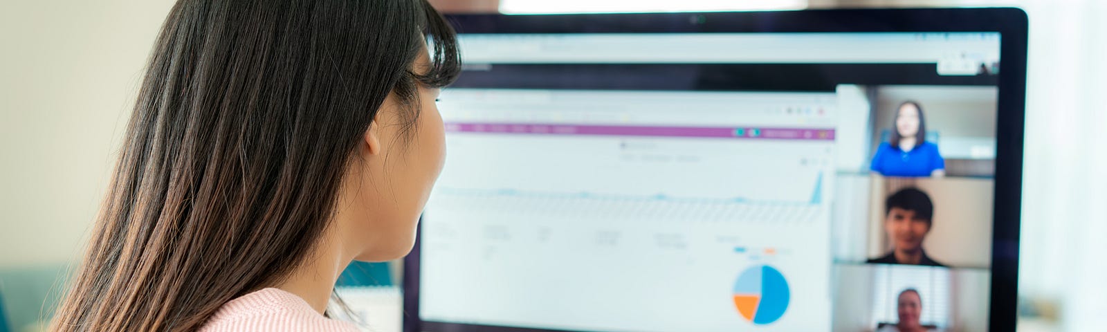 A photo of a woman in a video meeting for work.