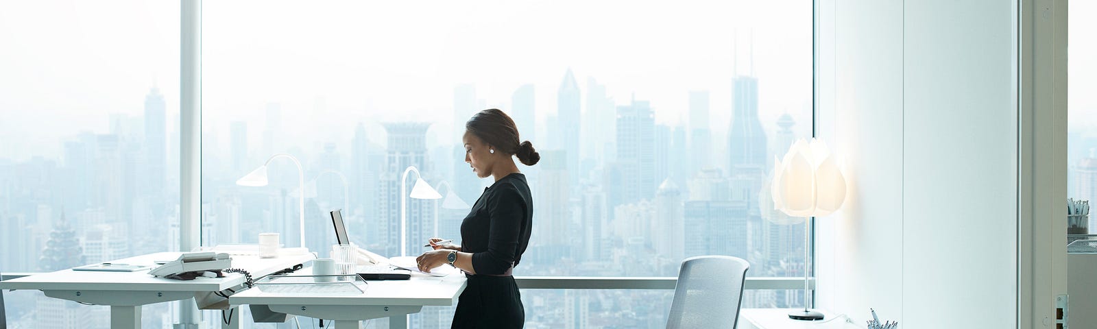 A Black businesswoman at work on her computer in her home office.