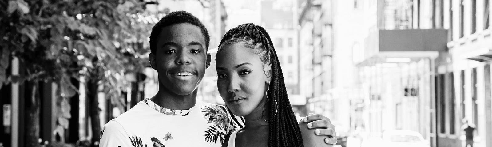 Black and white photo of the author and her son posing on a street.