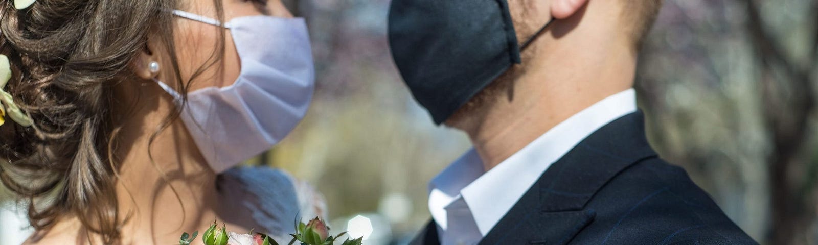 Bride and groom wearing mask at their wedding