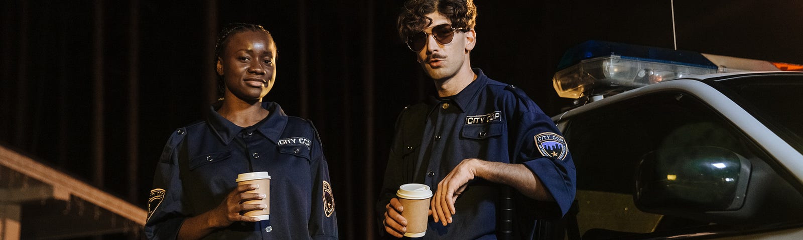 photo of two police officers with take-out coffee