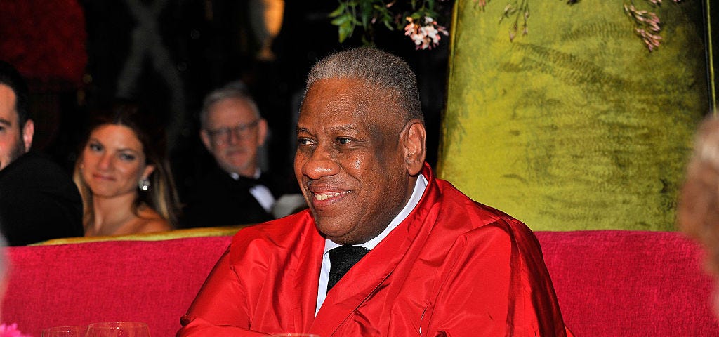 A photo of Andre Leon Talley wearing red at a premiere in San Francisco.