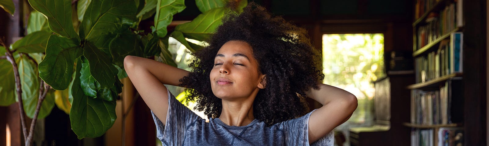 A photo of a young black woman relaxing at home.