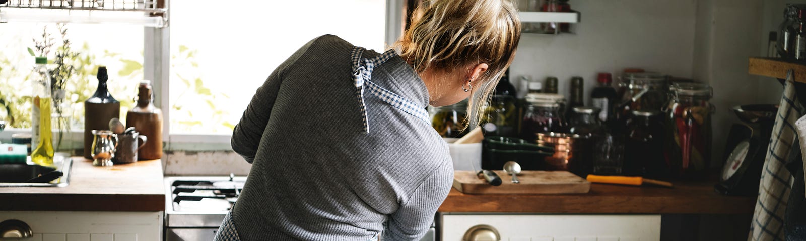 A woman cooking in her kitchen.