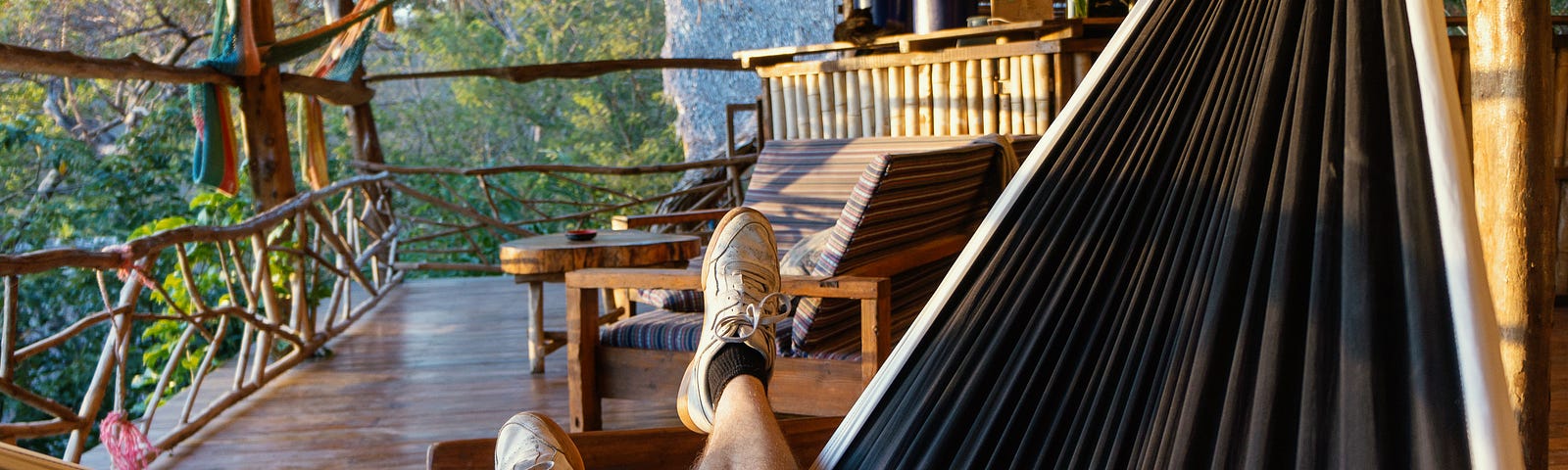 A person relaxing on a hammock while admiring the scenery.