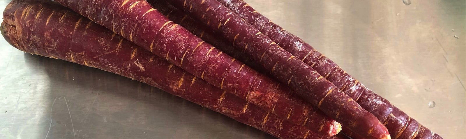 A stack of purple carrots.