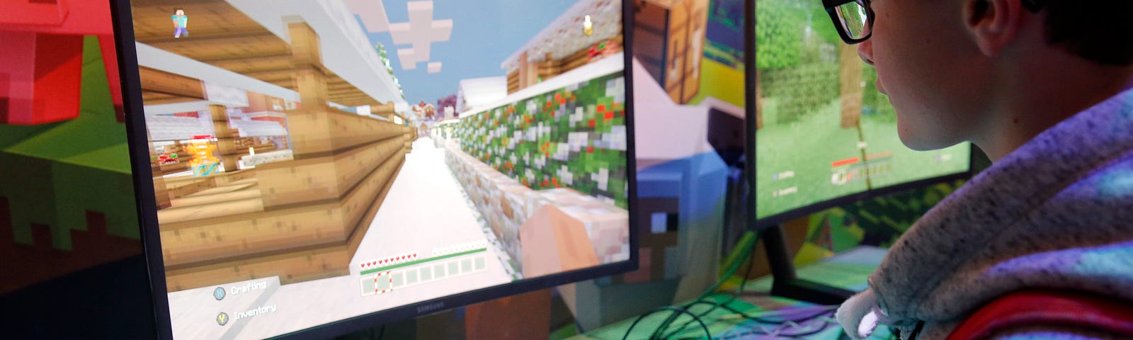 A person playing Minecraft on an XBOX connected to a monitor.